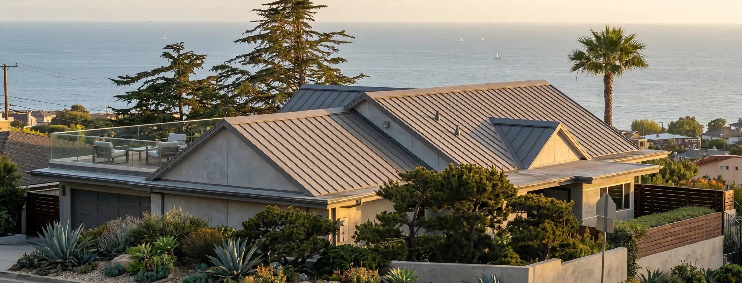 Aluminum standing seam metal roof on a modern coastal California home overlooking the ocean — Hybrid Renovations