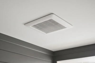 Ceiling exhaust fan grille set flush in the ceiling above charcoal shiplap walls after a remodel