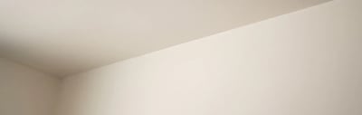 Clean paint cut line where the wall meets the ceiling after a bathroom refresh