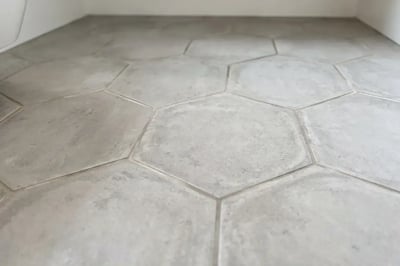 Gray hexagon tile floor after bathroom remodel flooring installation — Hybrid Renovations remodeling contractor