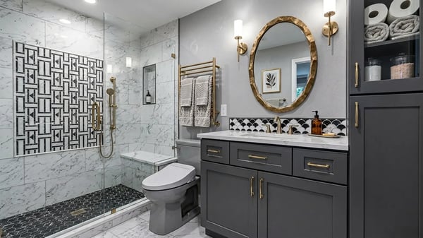 Marble tile shower with a geometric feature wall and charcoal vanity after a bathroom remodel — Hybrid Renovations
