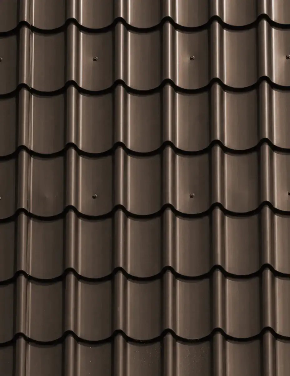 Burnished slate dark brown tile-profile metal roofing color option with curved barrel tiles