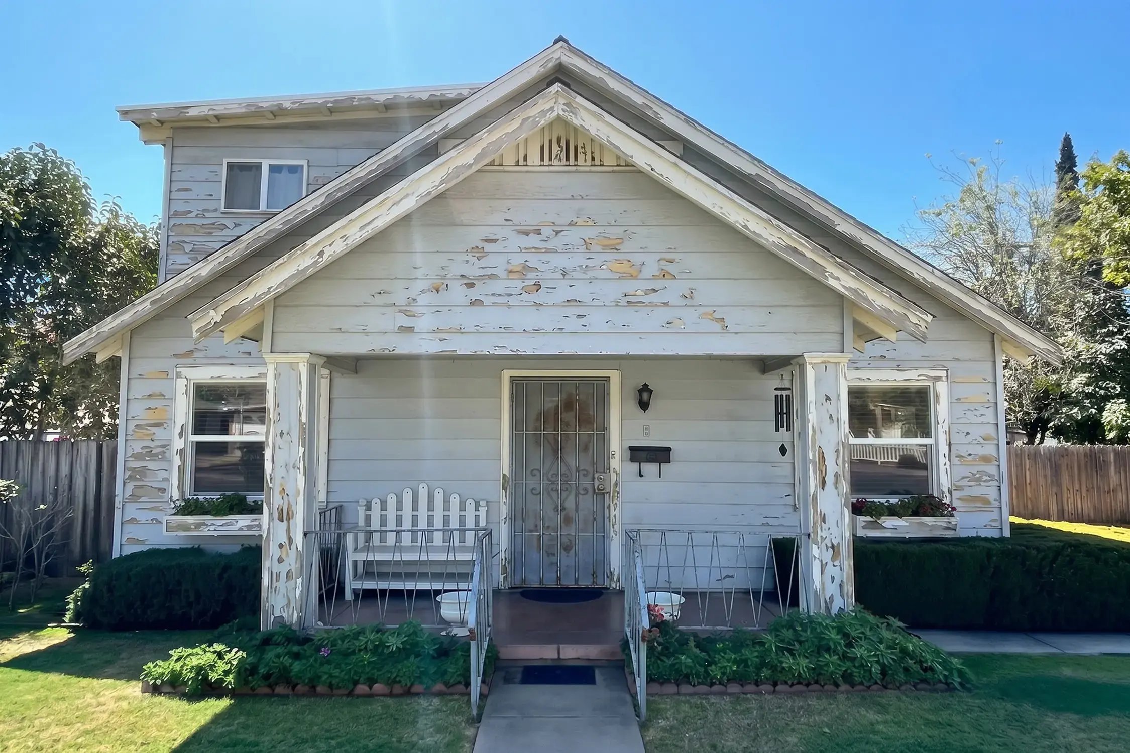 Weathered cream siding with heavily peeling paint before an exterior recoat on a craftsman bungalow in Claremont