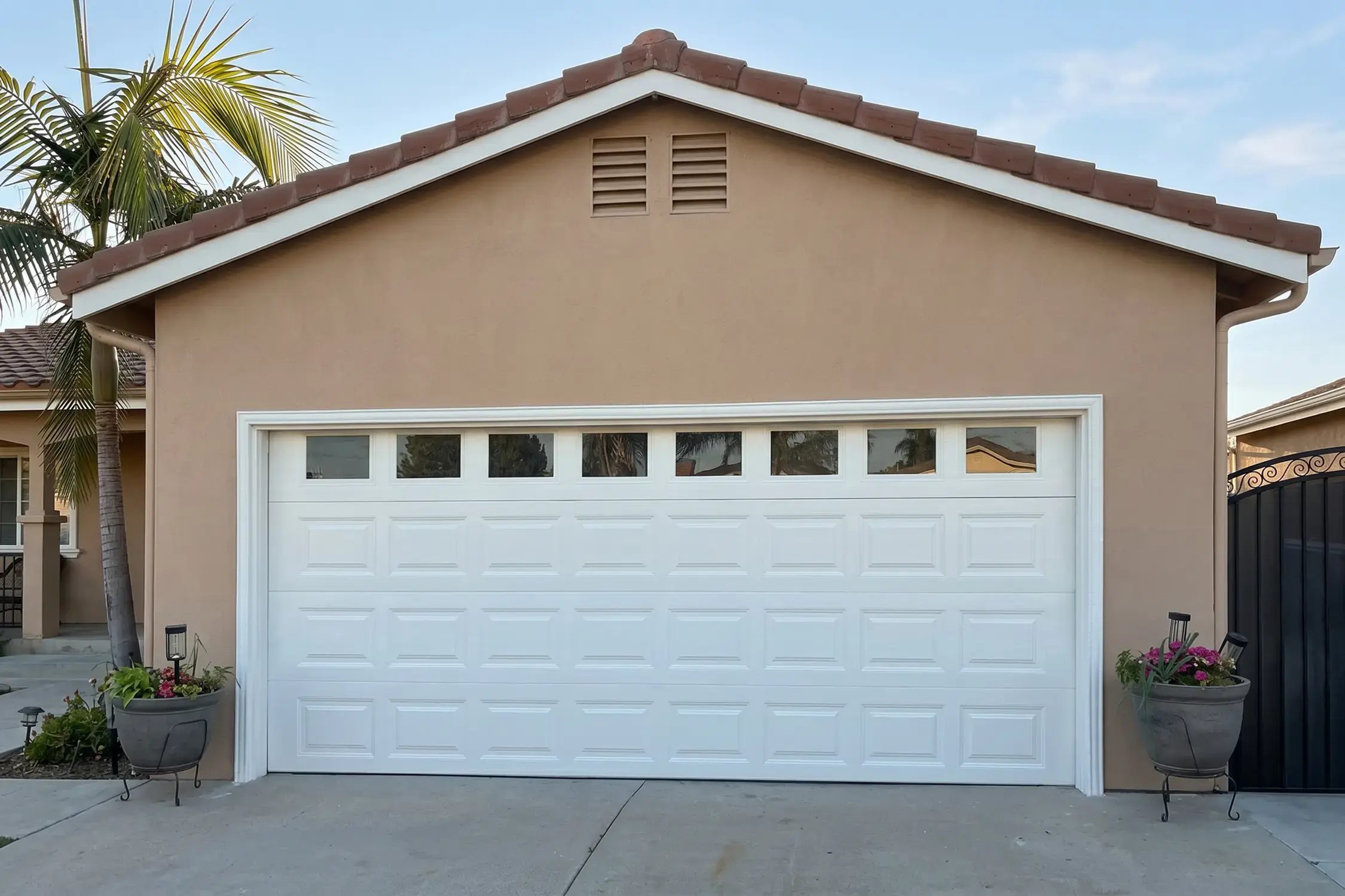 Two-car garage with white sectional door and repainted tan gable, Hybrid Renovations, Glendora