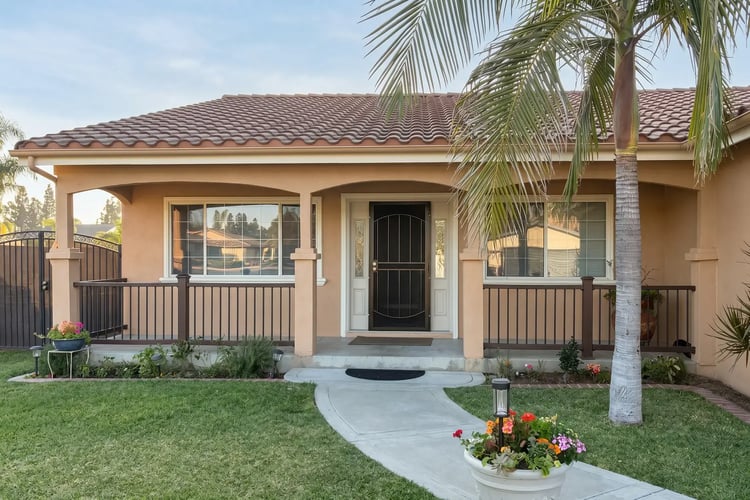 Exterior repaint with warm tan stucco and crisp white trim in Glendora
