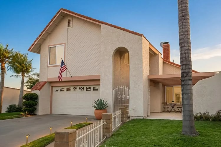 Full exterior repaint on a two-story stucco home in Anaheim