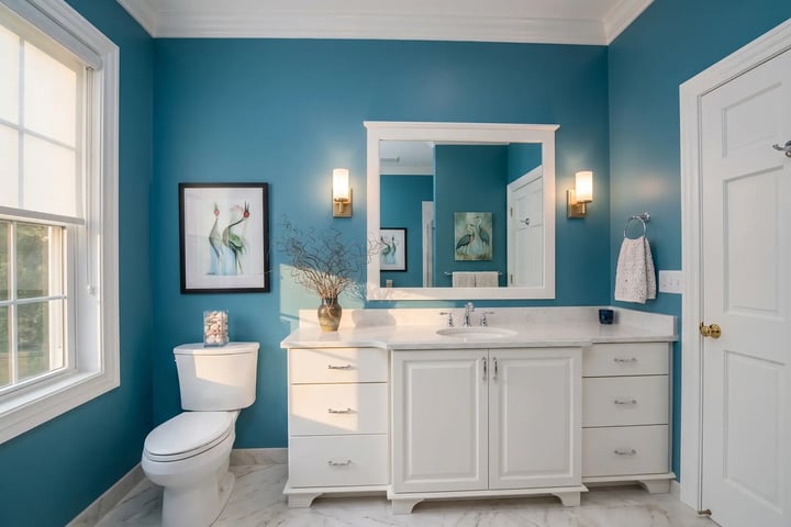 Teal-blue bathroom walls with white vanity and crisp white trim after residential interior painting