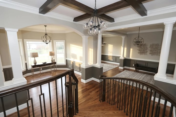 Greige walls flowing across an open living and dining room after whole-home interior painting — Hybrid Renovations