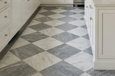 Grey and white marble checkerboard floor tile laid on the diagonal between kitchen cabinets