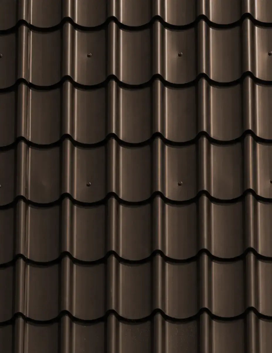 Mansard brown tile-profile metal roofing color swatch with curved barrel-style panels