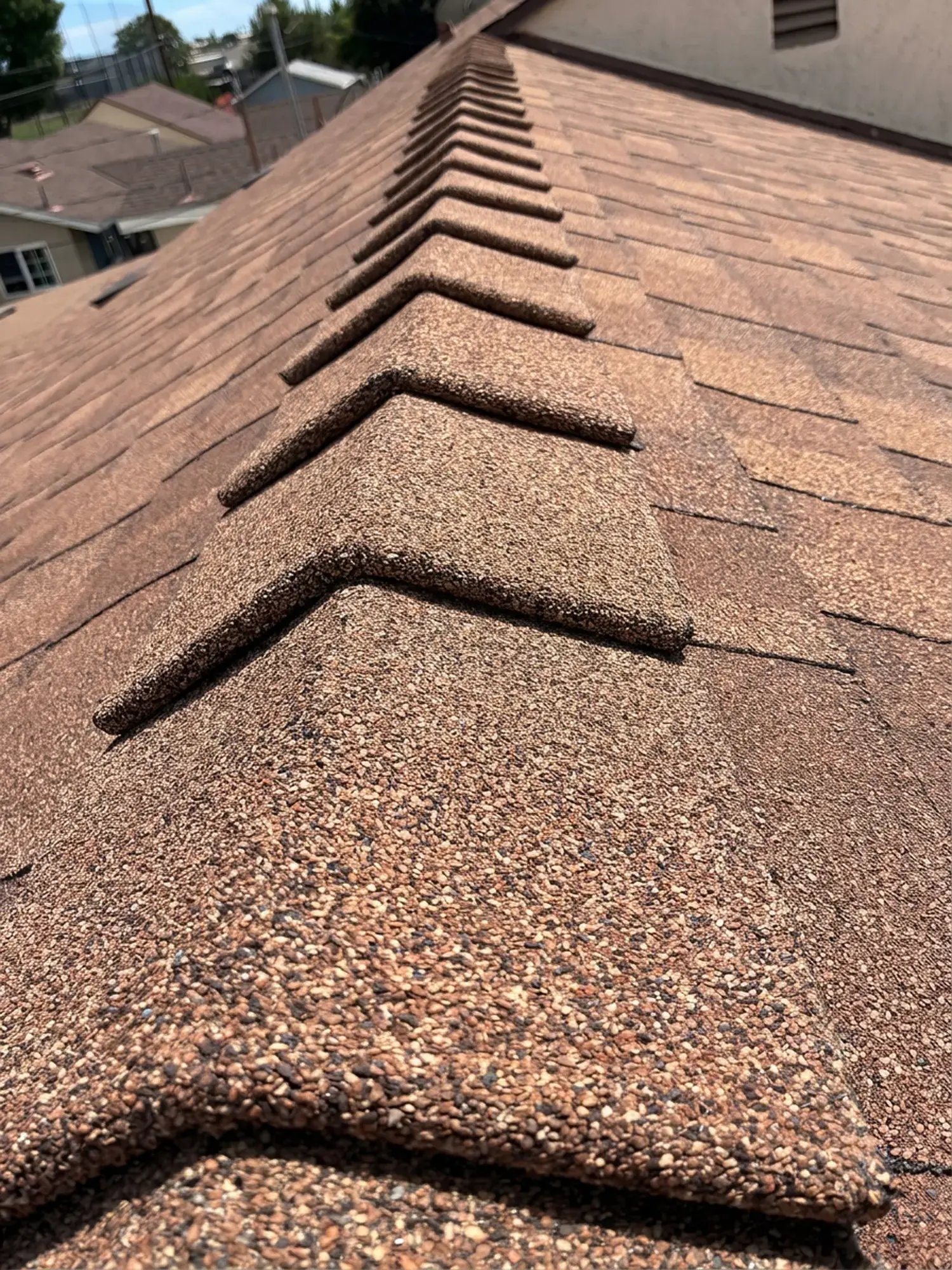 High-profile DecoRidge ridge cap running along the peak of the new Owens Corning roof by Hybrid Renovations, La Habra