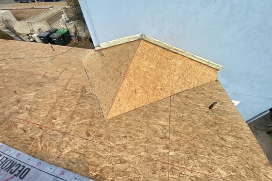 New radiant-barrier OSB sheathing installed over the rafters during a Hybrid Renovations re-deck in Orange