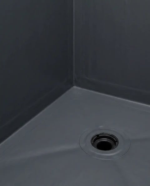 Waterproofing membrane running into the shower corner and bonded onto the drain flange before tile